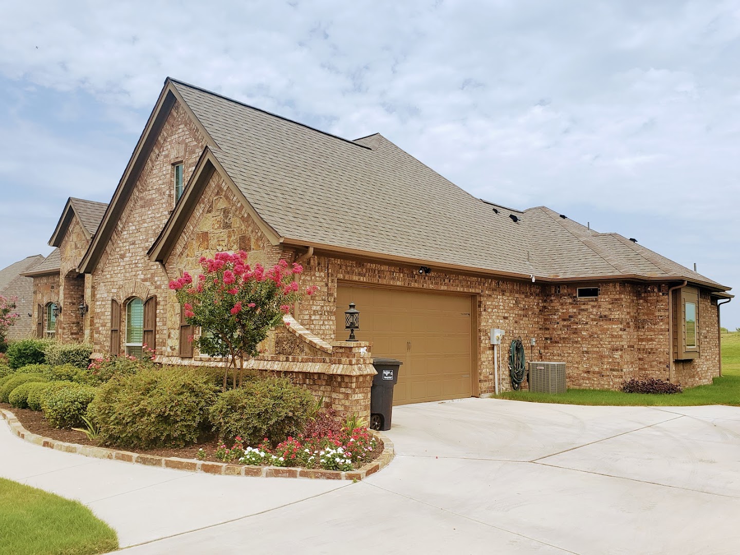 Completed residential roof on brick home
